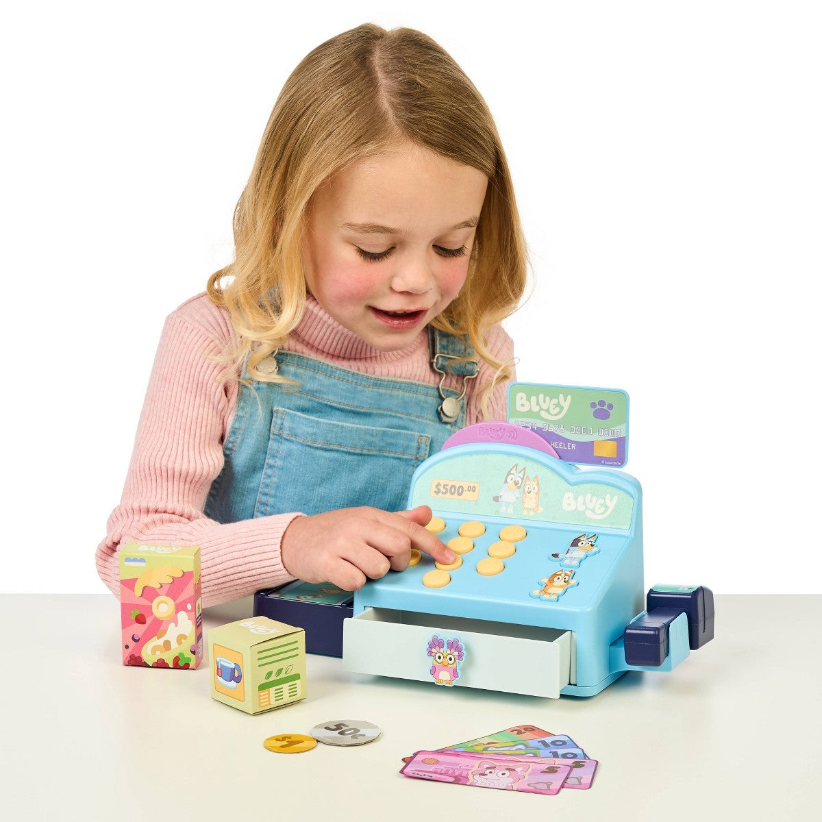 Child playing with Bluey Cash Checkout