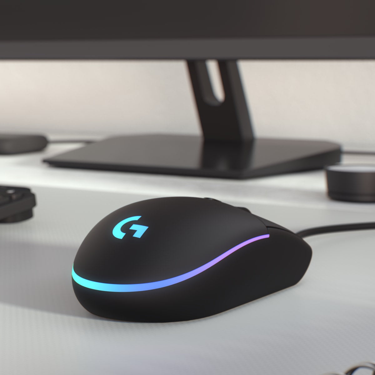 Logitech G203 LIGHTSYNC wired gaming mouse in black on a gaming desk
